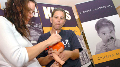Leeann Anderson, left, a member of the United Steelworkers Women of Steel, and Mary Sparks, a local union activist trained by the USW, test a doll for lead contaminants at Ms. Anderson's home in Mt. Lebanon.