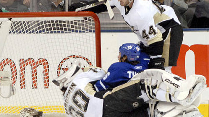 Penguins goalie Dany Sabourin holds his head after being run into by Toronto's Darcy Tucker. Sabourin had to leave the game.