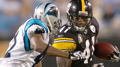 Running Back Gary Russell picks up yardage against the Panthers Thursday. Russell could be one of 22 players cut today.
