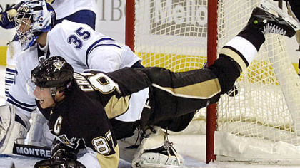  Penguins Sidney Crosby is airborne as he watches the play with Maple Leaf goalie Vesa Toskala at Mellon Arena.