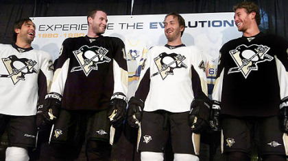 From left, the Penguins' Maxime Talbot, Ryan Whitney and Brooks Orpik model their team's new jerseys yesterday at the Galleria at Pittsburgh Mills. The Penguins' logo and colors remain unchanged, and the tighter-fitting uniforms look pretty much the same except for slightly altered striping in places and, for this season, a shoulder patch to commemorate Pittsburgh's 250th anniversary.