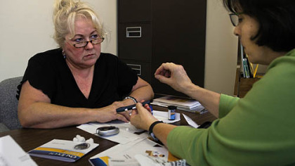 Joyce Tobias of Latrobe, left, newly diagnosed with diabetes, is instructed in how to use a blood sugar testing device by Sharlene Emerson, Diabetes Educator through UPMC.