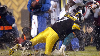 Quarterback Ben Roethlisberger brings down former teammate Joey Porter, now Dolphins' linebacker, after he intercepted a pass in the first quarter of last night's water-logged game at Heinz Field. (vs. Dolphins 11/26/07)