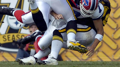 Steelers linebackers James Farrior and James Harrison take down Bills' Losman in the second quarter.