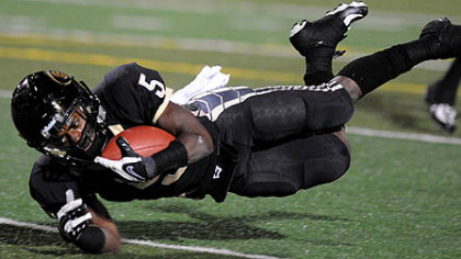 Gateway's Cameron Saddler dives into the end zone for the Gators' first touchdown in the first quarter against Penn Hills last night.
