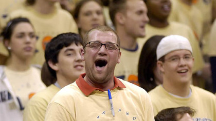 Ian Smith, president of the Oakland Zoo, cheers on the basketball team against Boston Tuesday.