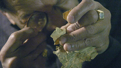 John Ford, curator at the Heinz History Center and Underground Railroad expert, examines a newspaper scrap found in a crawl space of the basement of the Jacob Witzel House on Evergreen Road to determine if the home was used as a safehouse for escaping slaves.