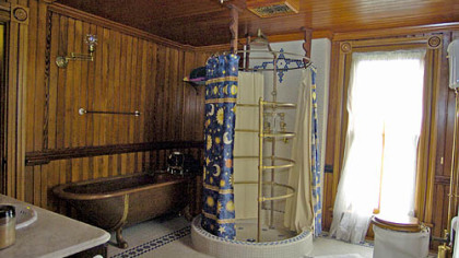 One of the bathrooms features a copper clawfoot tub with carp "legs" and an open circular shower.