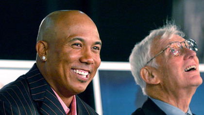 The Steelers' Hines Ward smiles to the audience while being introduced as a member of the Steelers All-Time Team. At right is team chairman Dan Rooney.