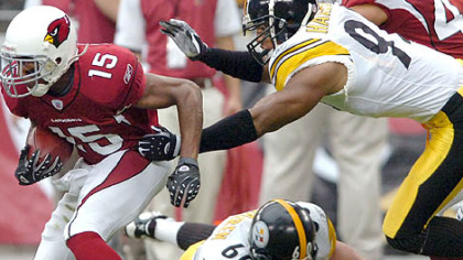 Cardinals wide receiver and North Braddock native Steve Breaston breaks away from Steelers linebacker James Harrison's coverage on a punt return.