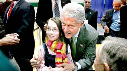 Former President Bill Clinton has his picture taken with a young girl as he greets Iowa residents at a campaign event for his wife, Democratic presidential candidate Sen. Hillary Rodham Clinton, D-N.Y., at Storm Lake Middle School in Storm Lake, Iowa, yesterday. According to polls, Mrs. Clinton is locked in a virtual tie with Sen. Barack Obama, D-Ill, and former Sen. John Edwards of North Carolina in the upcoming Iowa caucus.