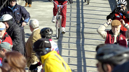 Pedestrians and bikers make their way across the Hot Metal Bridge yesterday.