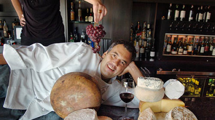 ill Fuller, corporate chef for big Burrito Group, is surrounded by artisan cheese -- and how about those grapes? -- at Eleven in the Strip District.