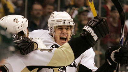 Evgeni Malkin celebrates with teammates after scoring one of his two second-period goals against the Wild last night in St. Paul, Minn.