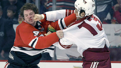 Daniel Carcillo, right, lands a punch on Chicago's Colin Fraser Friday on a night in which Carcillo logged 23 minutes of penalties.