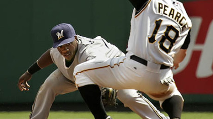 Steve Pearce tries to put on the brakes and avoid the tag of Milwaukee second baseman Rickie Weeks as he attempts to steal second base in the third inning.