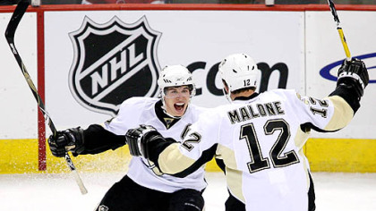 Sidney Crosby and Ryan Malone celebrate Malone's  first-period goal last night in Ottawa. The Penguins overcame two-goal deficits to win in a shootout.