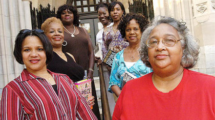 Seven members of the monthly reading group Sisters That Are Readers (STARS) gather at the Homewood Library. Clockwise from bottom left, are Nichole Jordan, M. Gayle Moss, Mercedes Taylor, Velma Harris, Denice Coker, Vivian Shelton and Donna Stilo.