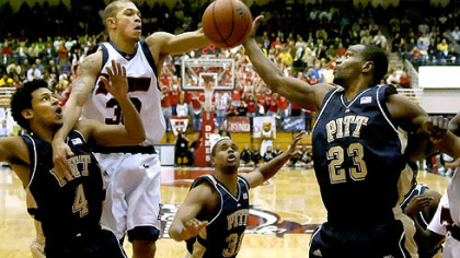 From left, Pitt's Ronald Ramon, Mike Cook and Sam Young fight under the basket for a rebound against Duquesne's Bill Clark last night at the Palumbo Center. Pitt won, 73-68. (at Dukes 12/05/2007)