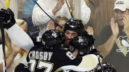 Ryan Malone, center, celebrates with teammates after scoring the winning goal against the Ducks last night at Mellon Arena.