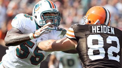 Miami Dolphins linebacker Joey Porter is blocked by the Browns' Steve Heiden yesterday in Cleveland.