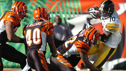 Steelers wide receiver Santonio Holmes makes catch from Roethlisberger as he is grabbed by Buffalo's Ashton Youboty 26. At right is Buffalo's Paul Posluszny.