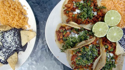 Two dishes on the menu at Taqueria Taco Loco are Enchiladas de Mole (chicken), left, and Pastor Taco (marinated pork meat).