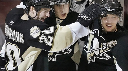 The Penguins' Colby Armstrong, left, celebrates his first-period goal against the Sabres with Evgeni Malkin, center, and Sidney Crosby Saturday night at Mellon Arena.