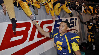 West Virginia's Pat White celebrates winning the Big East championship by defeating Connecticut 66-21.