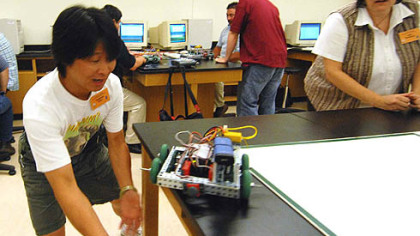 Clarence Chu, of Dayton, Ohio, prepares to catch his team's wayward robot as his teammate Julie Sweeney, of Sioux City Iowa, watches during last week's robotics conference at Butler County Community College.