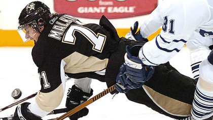EvgenI Malkin is pulled down by the Maple Leafs' Pavel Kubina last night at Mellon Arena.