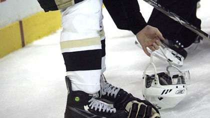 Sidney Crosby retrieves his helmet after having it knocked off on a check into the boards. (at Flyers 11/10/07)