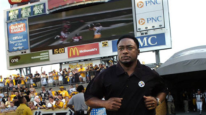 Steelers head coach Mike Tomlin runs on to Heinz Field for the first time against the Green Bay Packers Aug. 11.