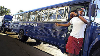 Penn State's football team arrives on buses yesterday morning to clean the stands at Beaver Stadium.