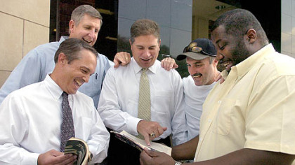 Members of the 1982 Penn State national championship team, left to right, Dan Biondi, Bill Contz, Mark Battaglia, Gregg Garrity and Joel Coles, look over old Sports IIlustrated magazines of their season.
