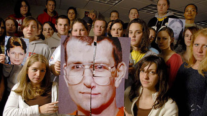 Members of the Forensic Investigation I class at Duquesne University hold a photo of convicted serial killer Keith Hunter Jesperson, with whom they corresponded during the fall semester. Other students hold photos of Mr. Jesperson's victims.