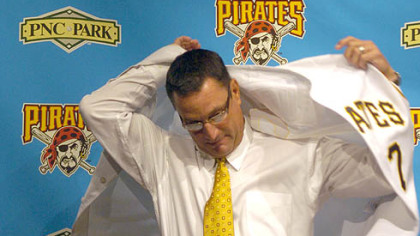 John Russell tries on a Pirates jersey after being introduced as the 38th manager of the team yesterday at PNC Park.