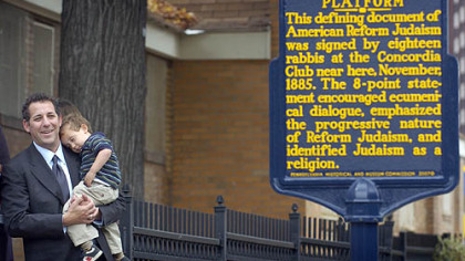 Rabbi Aaron Bisno of Rodef Shalom Congregation holds son Adam, 2, shortly after the unveiling yesterday of a marker noting the historic Pittsburgh Platform on Stockton Street on the North Side.