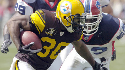 Steelers defensive back Allen Rossum returns a kickoff as the Bills' Mario Haggan defends.