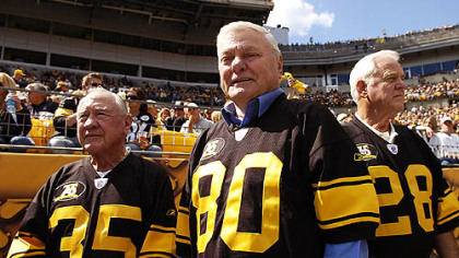 Mr. Butler, center, with fellow Legands Team members Bullet Bill Dudley, left, and Clendon Thomas, right, after being honored at last Sunday's game at Heinz Field.