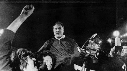 Steelers head coach, Chuck Noll, is carried off the field by his players led by defensive standout #75 Joe Greene. The Steelers won their third Super Bowl defeating the  Dallas Cowboys 35-31.