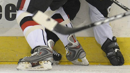 Sidney Crosby battles for a loose puck with the Canadiens' Andrei Markov in the first period at Mellon Arena last night.