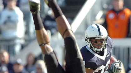 Derrick Williams upends Purdue's David Pender, opening a hole for Penn State's Evan Royster.