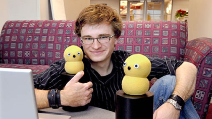 Marek Michalowski, 27, with two of his Keepon robots.