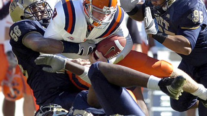 Pitt's Joe Clermond, left, Ernest Williams, right, and Greg Romeus take down Syracuse's Andrew Robinson.