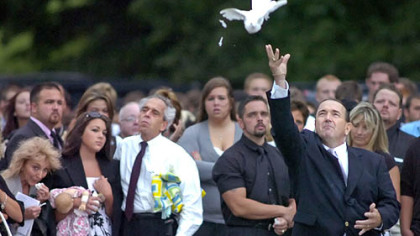 Norm Brozovich of Memory Makers White Dove Releases frees the first of 21 white doves as mourners gathered following the funeral of slain Gateway High School cheerleader Demi Cucci at the Monroeville Assembly of God yesterday.