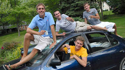 
Quadruplets Brian, in driver's seat, Doug, left, Matt and Mike Heckman show off their newly obtained driver's licenses. The 16-year-olds passed their driver's tests exactly six months after they received their permits. They are on one of the two cars their parents bought for them to share.