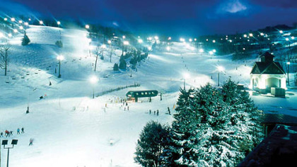 Bright lights and noisy snowmaking towers greet skiers and snowboarders as they head for the six-passenger Coco Cola Polar Bear Express lift at Seven Springs for an evening of fun on the slopes.