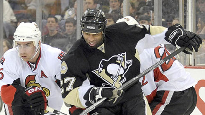 Penguins' Georges Laraque battles for a loose puck against Ottawa on Thursday. (12/13/2007)