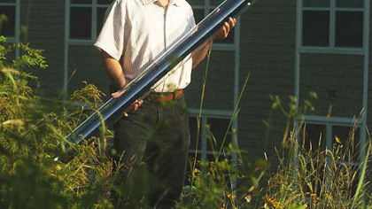 Doug Oster/Post-Gazette
Ernie Sota of Sota Construction Services Inc. poses with a evacuated tube collector at the RossHill Retirement Residence in Ross. The tube will be installed to complete a solar domestic hot water heating array on top of the roof of the building.